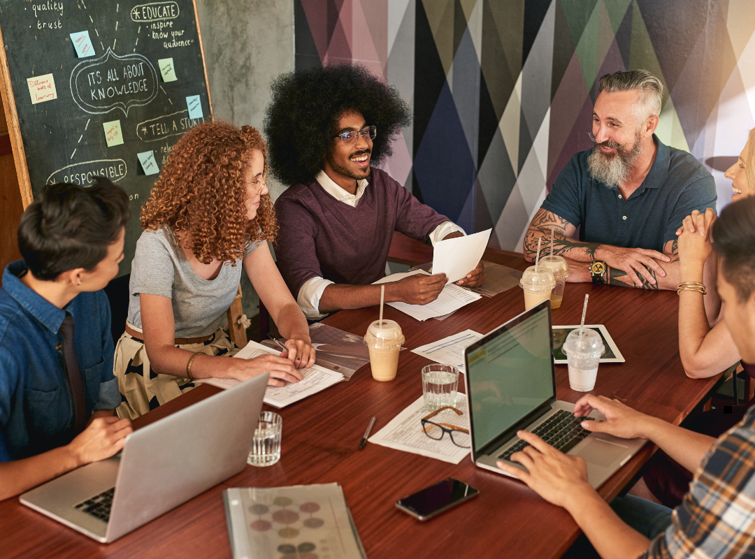 Group of people sitting around a table collaborating