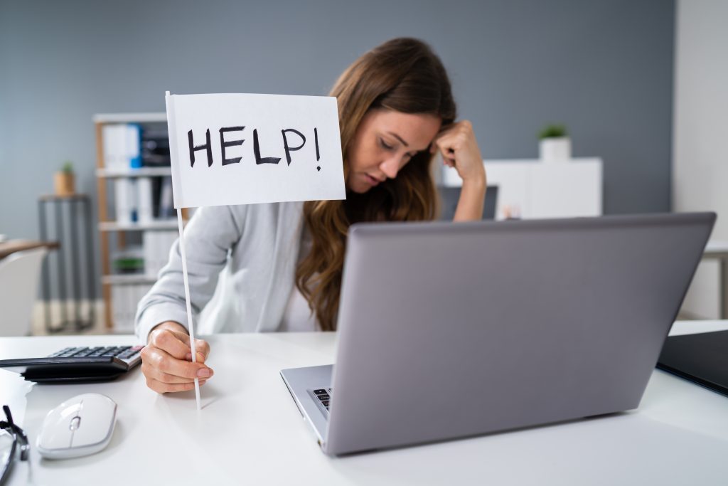 Businesswoman Showing Help Flag In Office