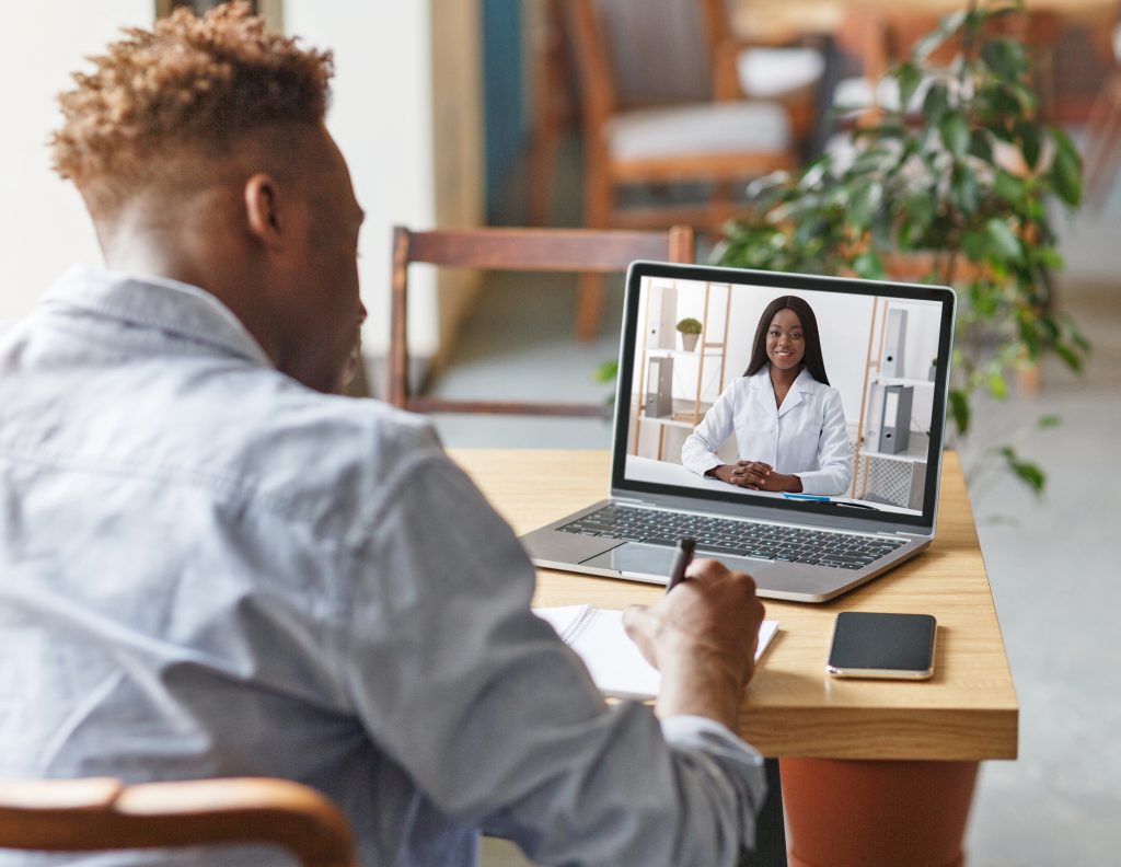 Appointment with doctor online. Black guy having video chat with therapist, receiving professional medical help remotely. African American patient on distance meeting with general practitioner