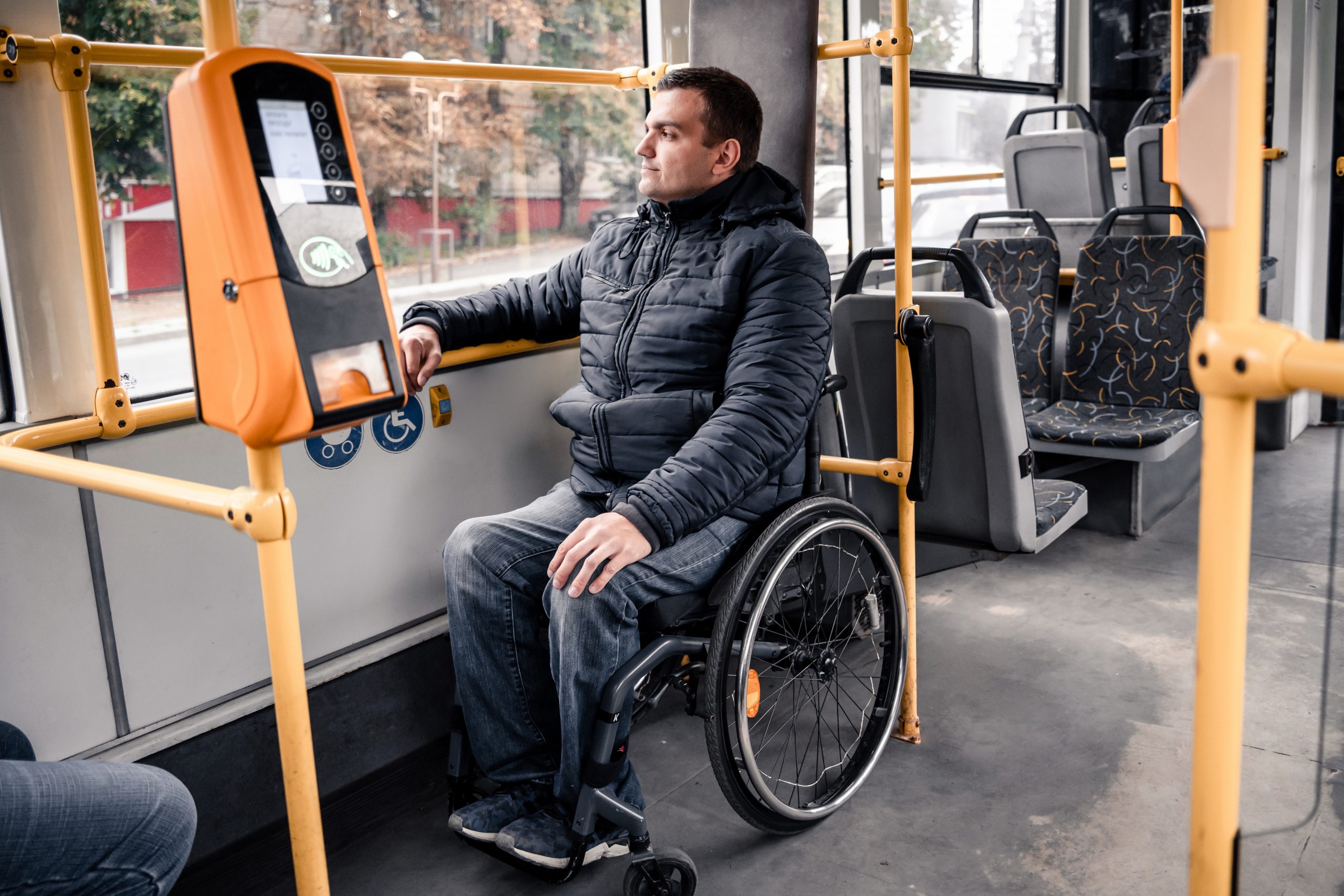 Person with a physical disability inside public transport with an accessible ramp.