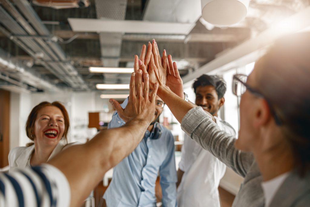 Group of coworkers stacked hands together as concept of corporate unity. High quality photo
