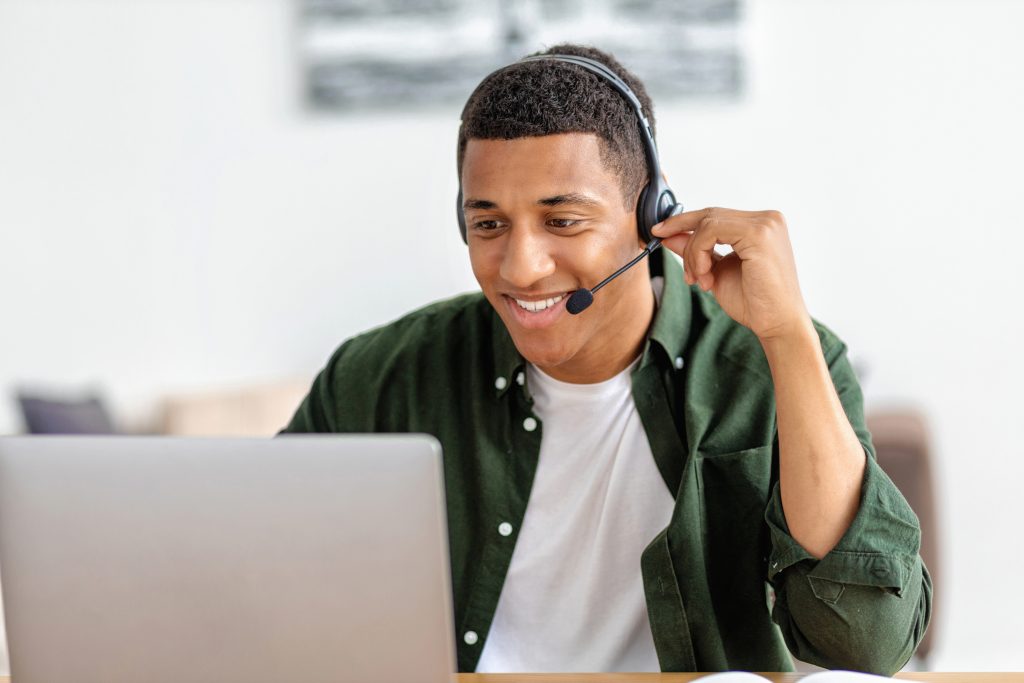 Portrait of happy African American male employee customer support services in headset, online consultation. Call center, customer support or sales man agen