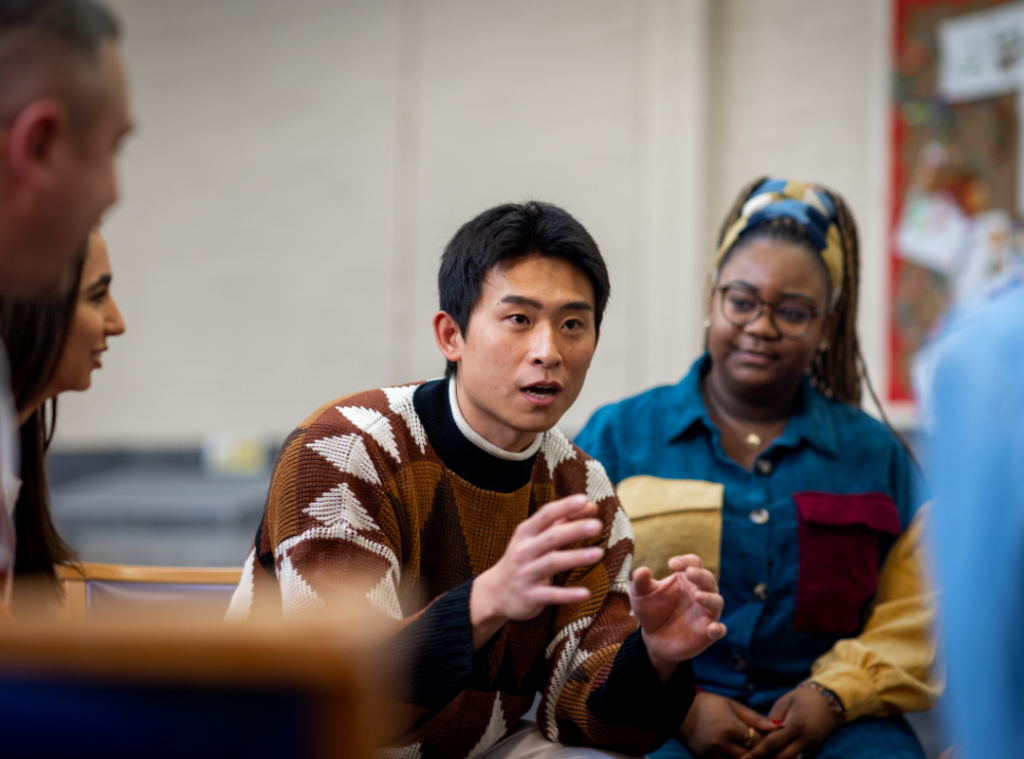An oriental man and black woman having an animated discussion