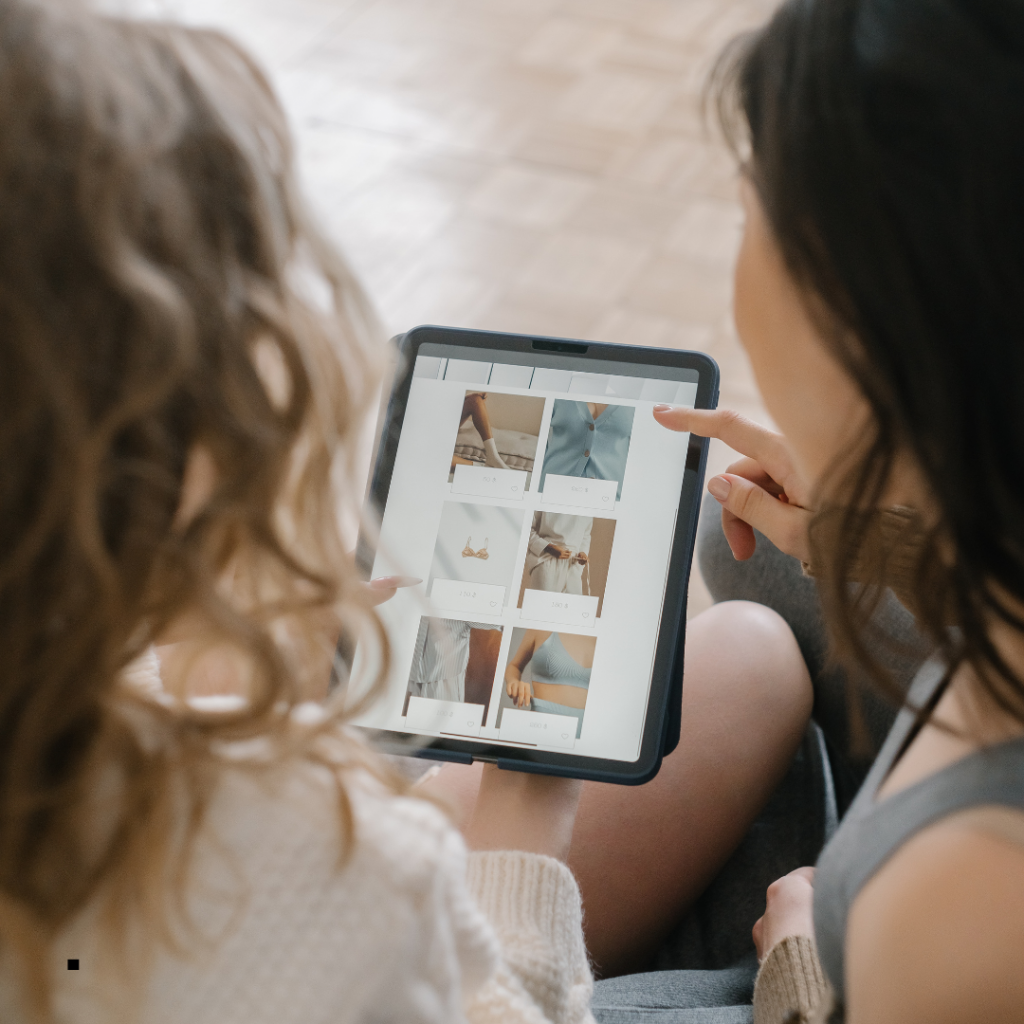 Two white women looking at an Ipad screen