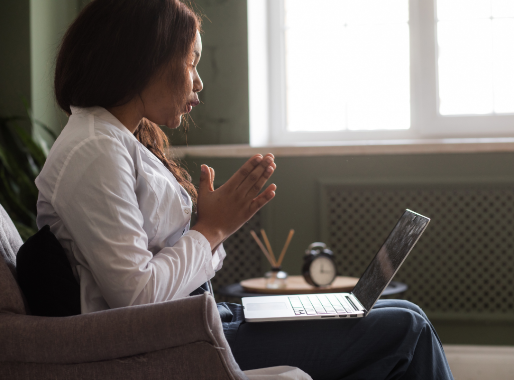Old black woman talking to her GP via virtual consultation